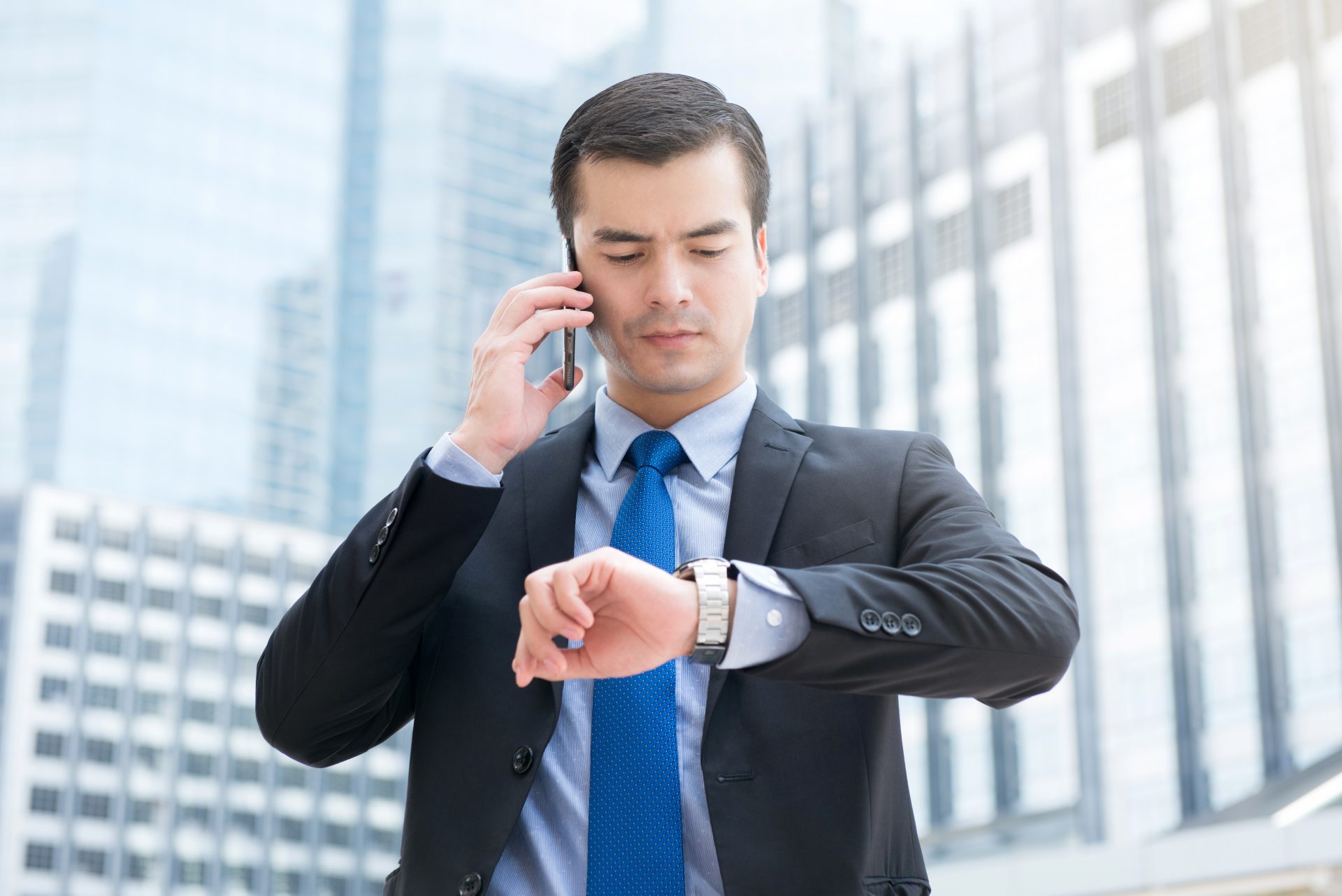 Look at his. Person looking at a watch. Looking at his watch. The businessman looks at his watch. Man looking at watch.