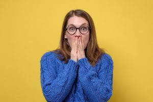 example of a young woman embarrassed by a chipped tooth