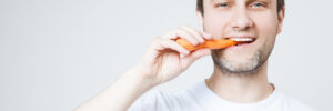 Man eating carrot
