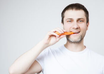 Man eating carrot