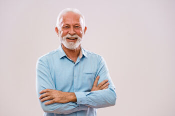 Senior man smiling on white background