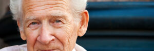face portrait of a cheerful smiling senior man