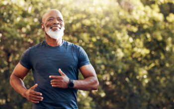 Smiling man running in park