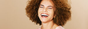 Woman laughing with curly hair