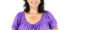 Smiling woman in purple blouse