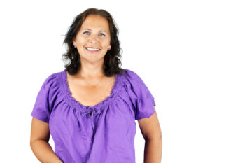 Smiling woman in purple blouse