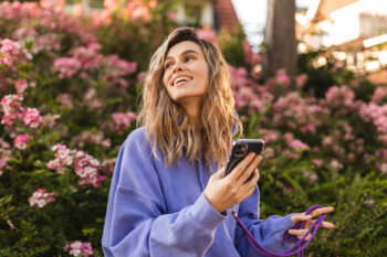 Blonde woman on phone outside