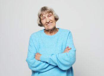 Happy grandmother wearing blue sweater smiling