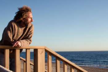 pensive middle-aged man looking to the horizon and sunlight on his face